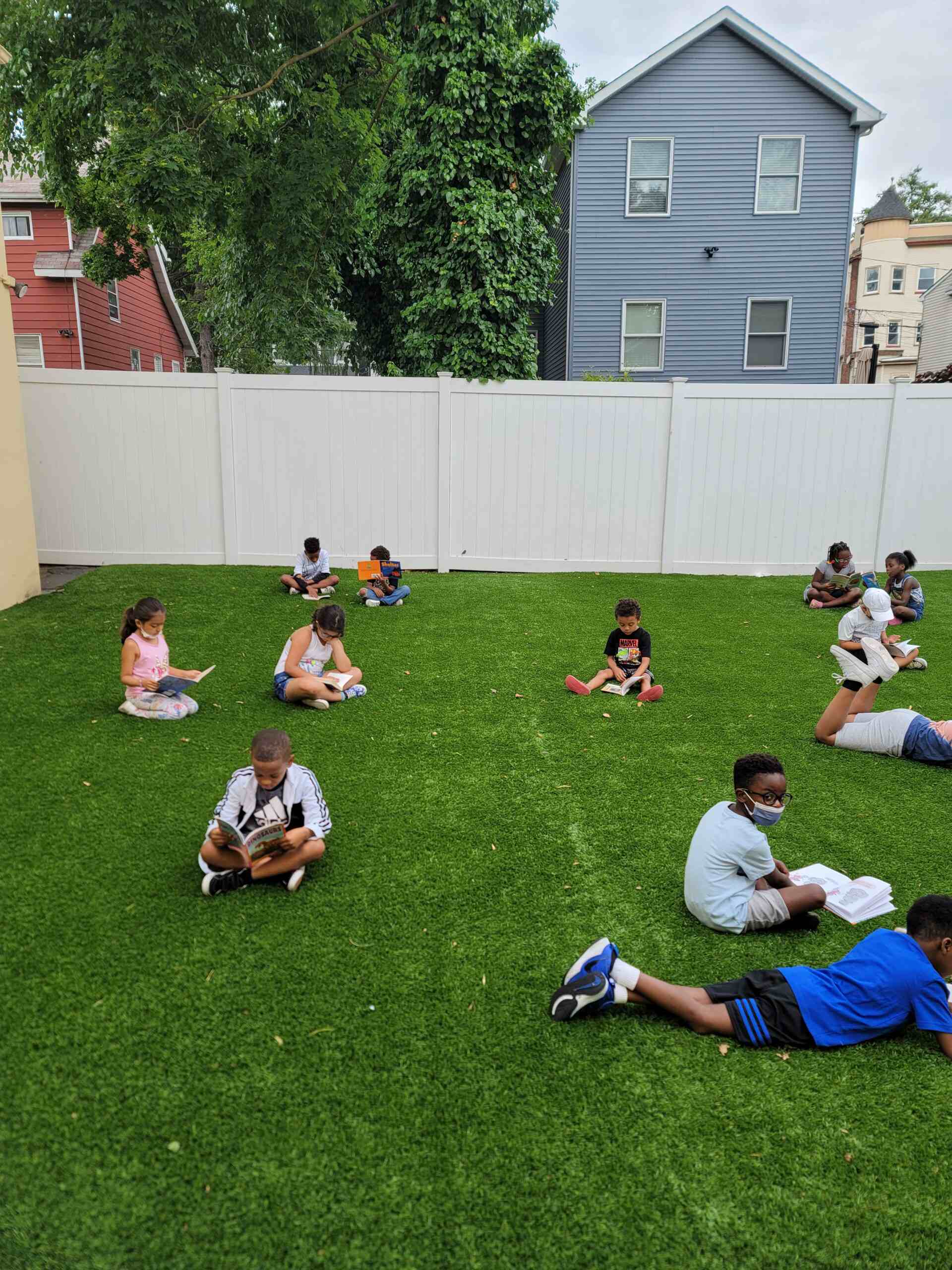 SO many small children playing in a ground