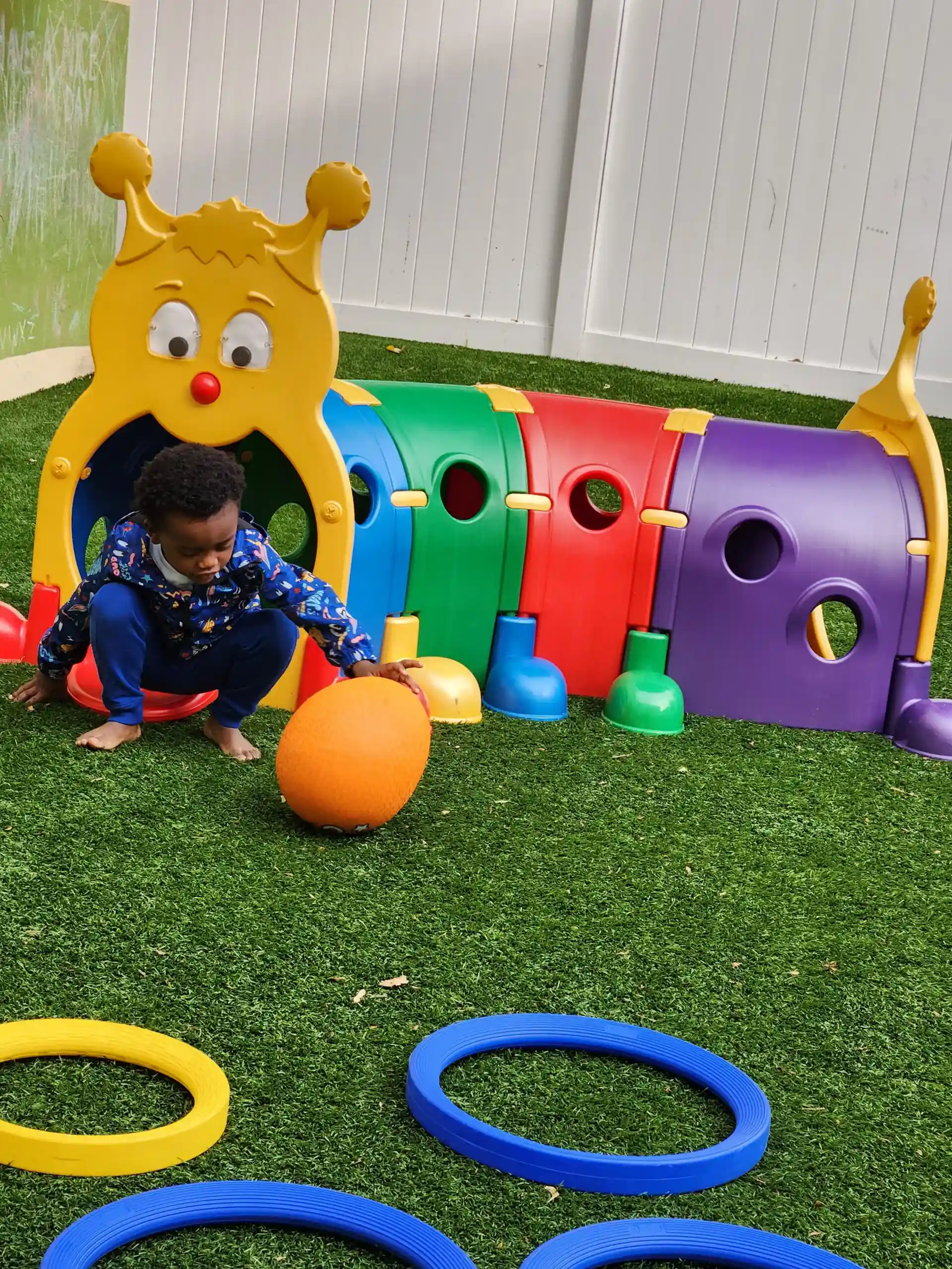 Some children playing in a field in a ground